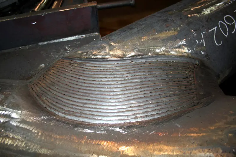 Superficie in acciaio ricostruita con numerose passate di saldatura